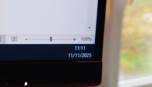 a computer screen showing the time as 11:11 on 11/11/2025