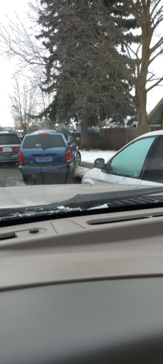 suv without plates parked cockeyed on the sidewalk 